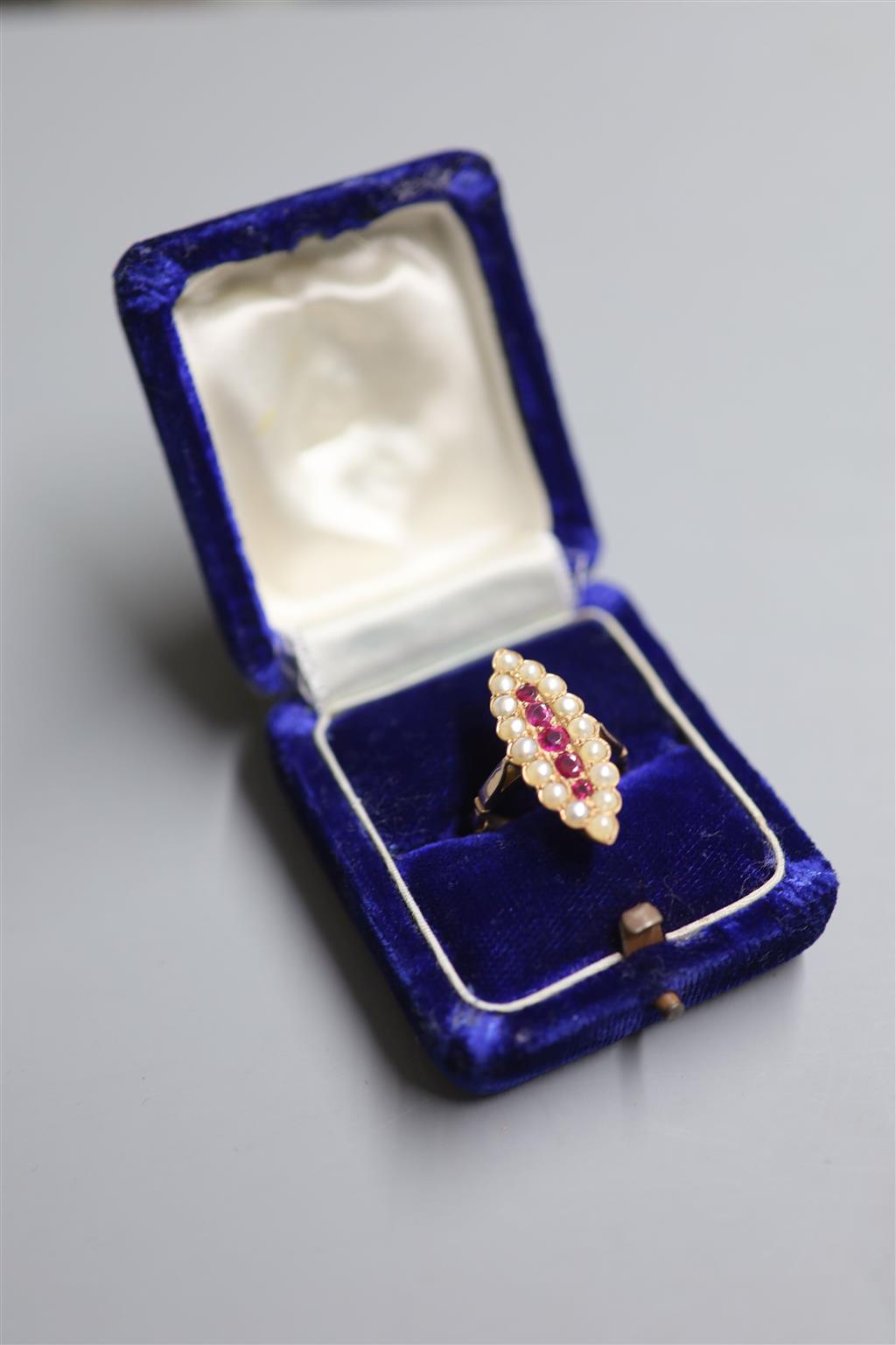 A yellow metal, ruby and split pearl cluster set marquise shaped dress ring, size Q, gross 5.8 grams.